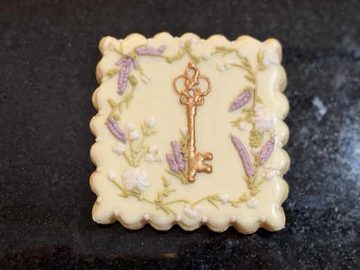 Gold key on hand-piped lavender