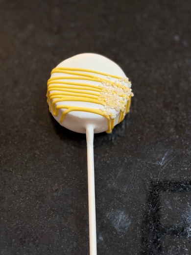 Lemon cake pop with yellow drizzle